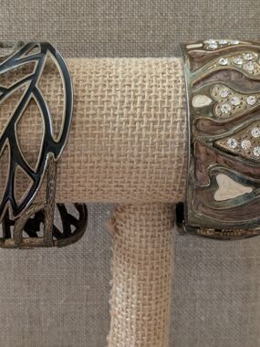 Pair of Decorative Metal Cuff Bracelets in Silver and Brown Tones